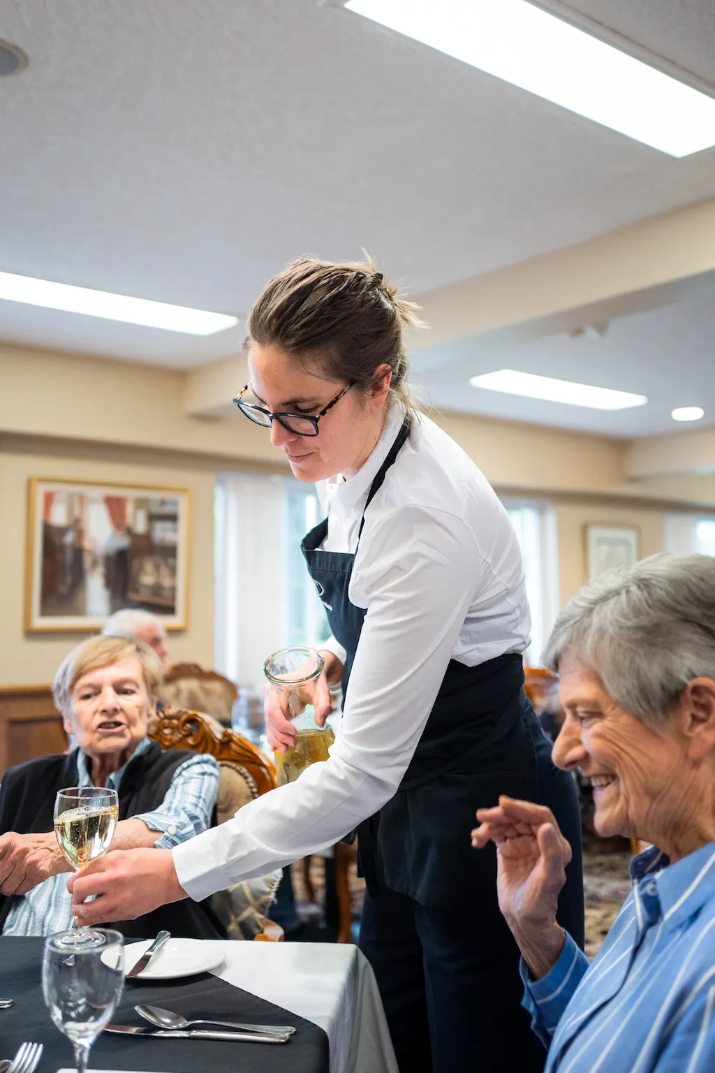 staff serving a meal at Renaissance Retirement Residence in Victoria, BC